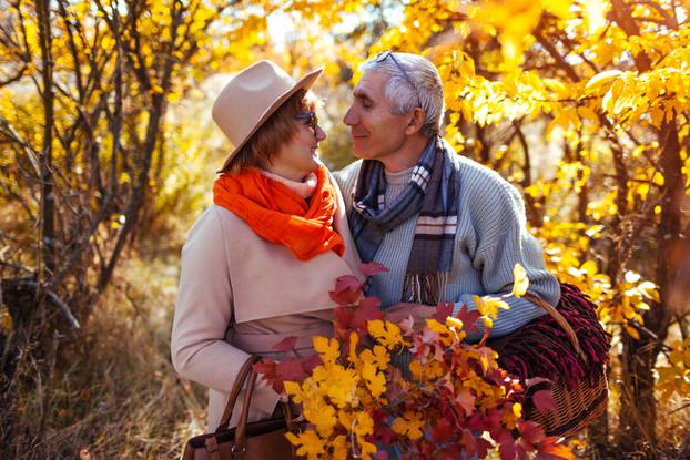 Senior,Couple,Walking,In,Autumn,Forest.,Middle-aged,Man,And,Woman