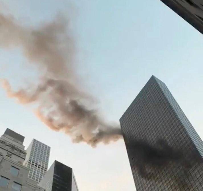 A smoke is seen rising from the roof of Trump Tower, in New York