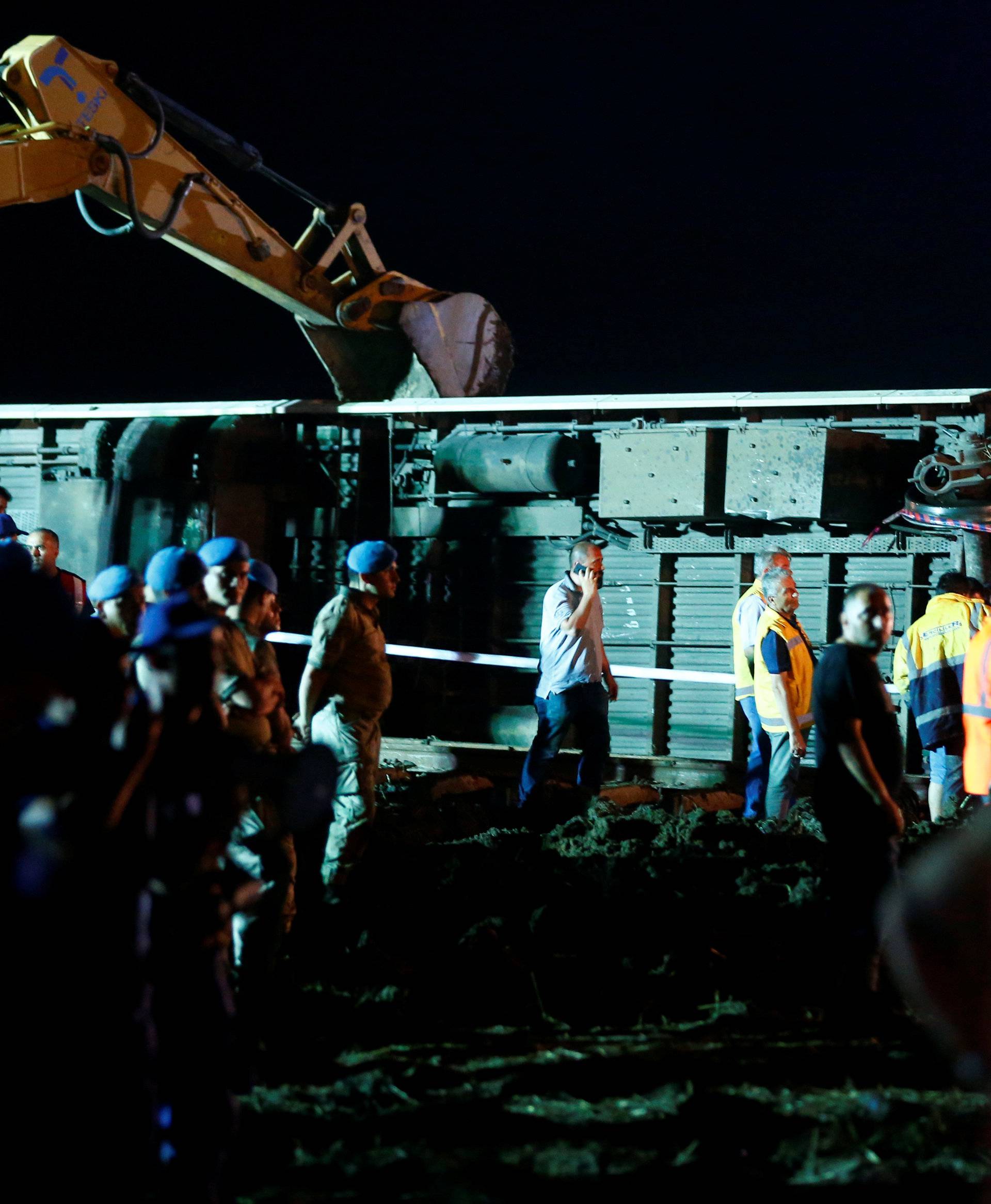 Rescue workers and paramedics work at the site of a train derailment near Corlu in Tekirdag province, Turkey