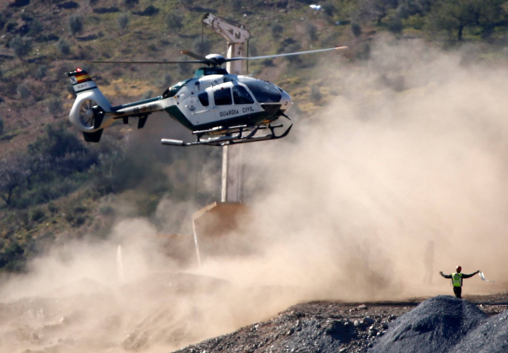 A Spanish Civil Guard helicopter lands carrying boxes with explosives picked in Sevilla at the area where Julen, a Spanish two-year-old boy, fell into a deep well, in Totalan