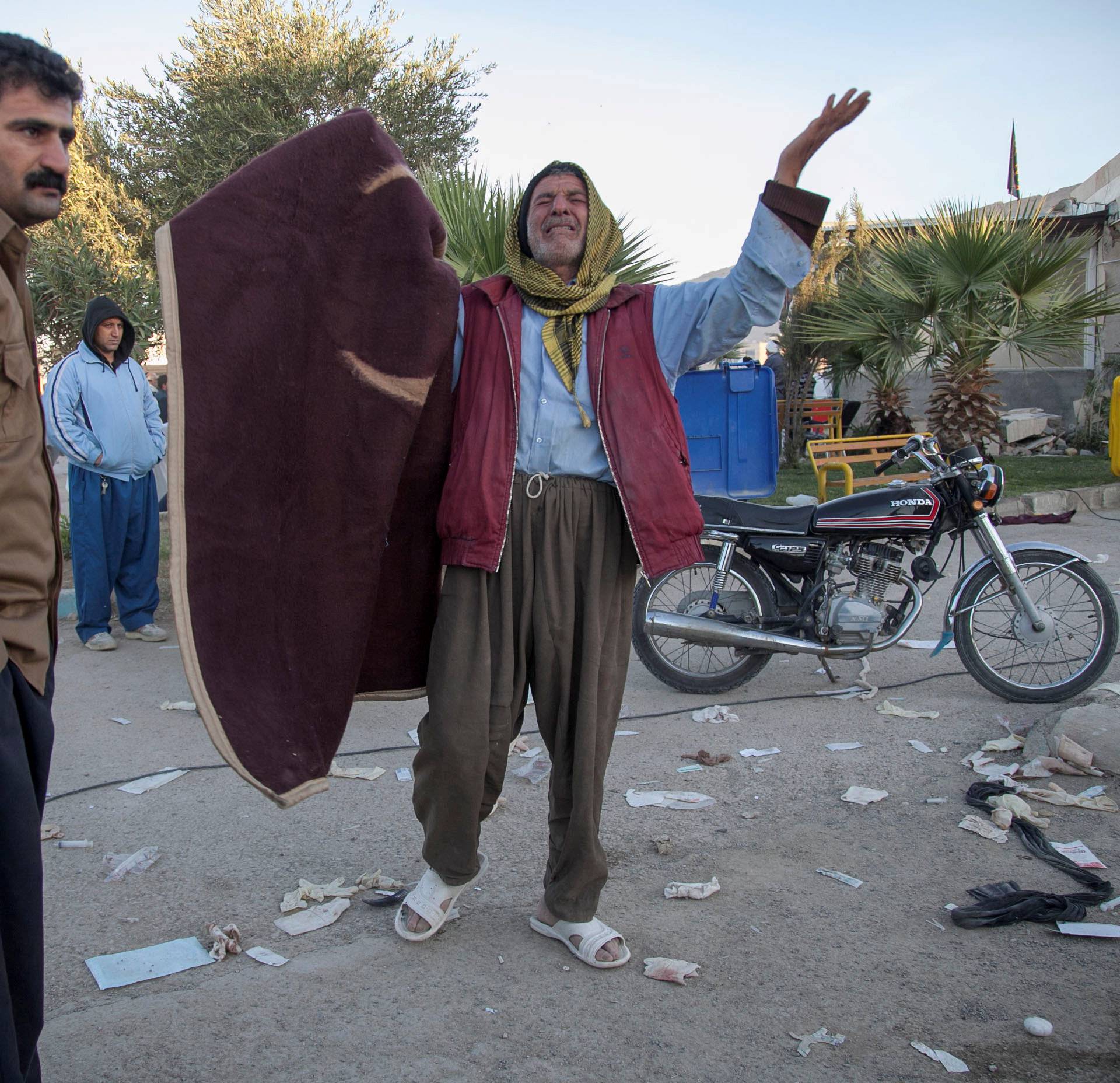 A man reacts following an earthquake in Sarpol-e Zahab county in Kermanshah