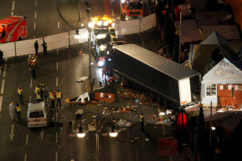A tow truck operates at the scene where a truck ploughed through a crowd at a Berlin Christmas market
