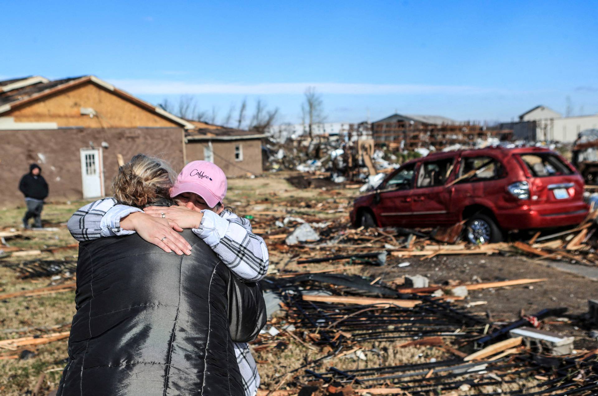 Irene Noltner consoles Jody O'Neill outside destroyed women's shelter in Mayfield