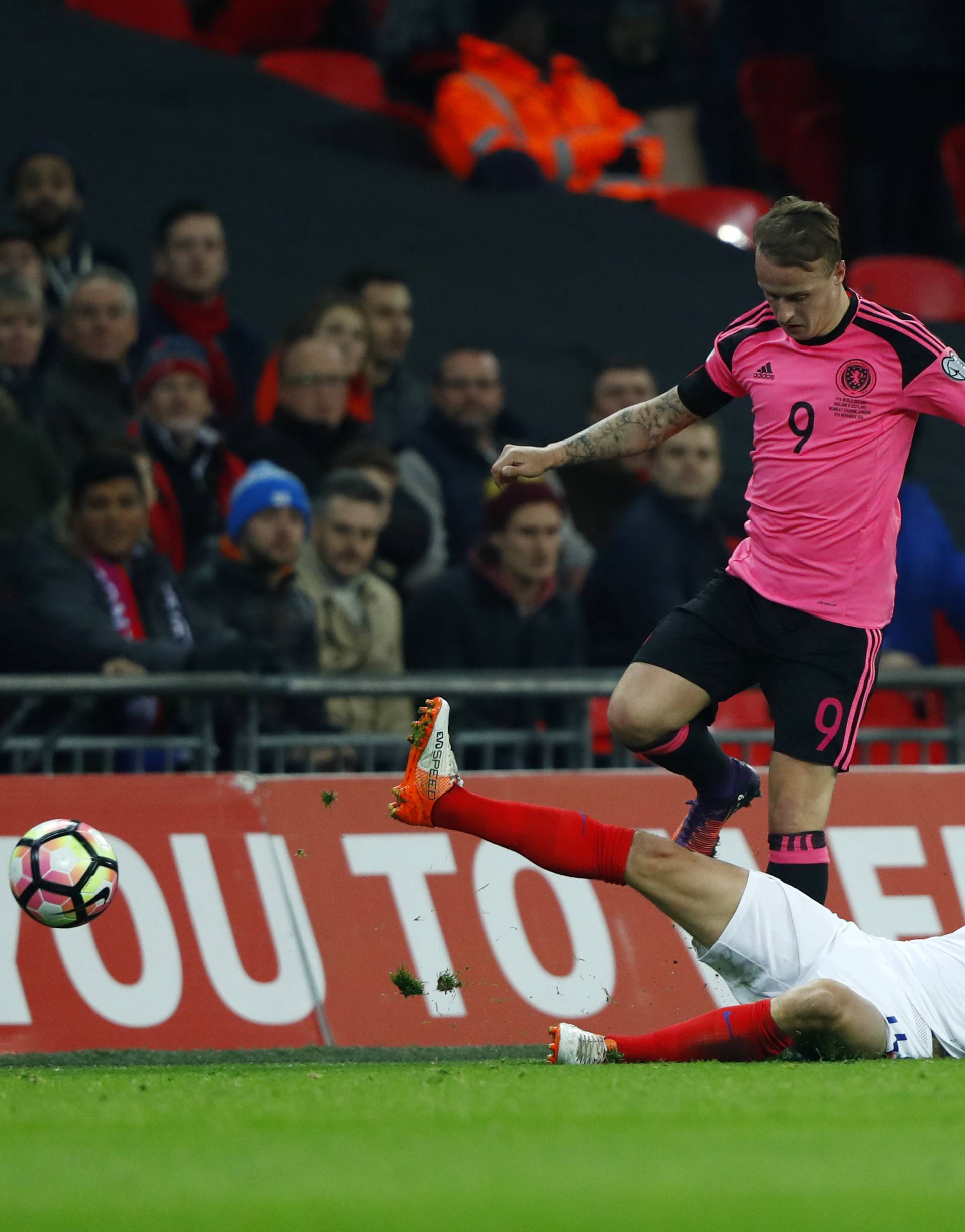 Scotland's Leigh Griffiths in action with England's Adam Lallana