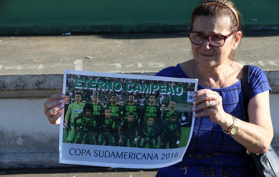 A fan of Chapecoense soccer team shows a poster of her team at the Arena Conda stadium in Chapeco