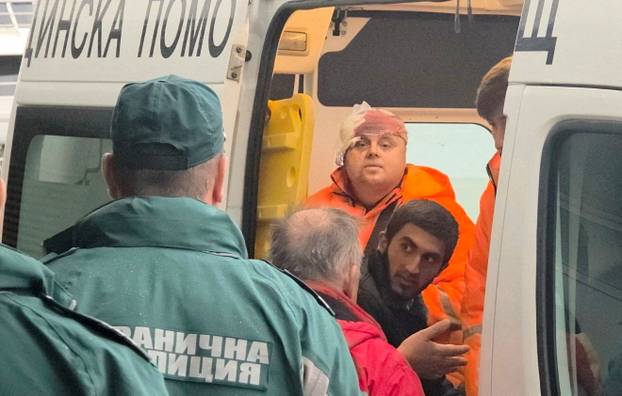 Rescued crew members from a ship that was damaged in drone attack are taken away in an ambulance in Varna