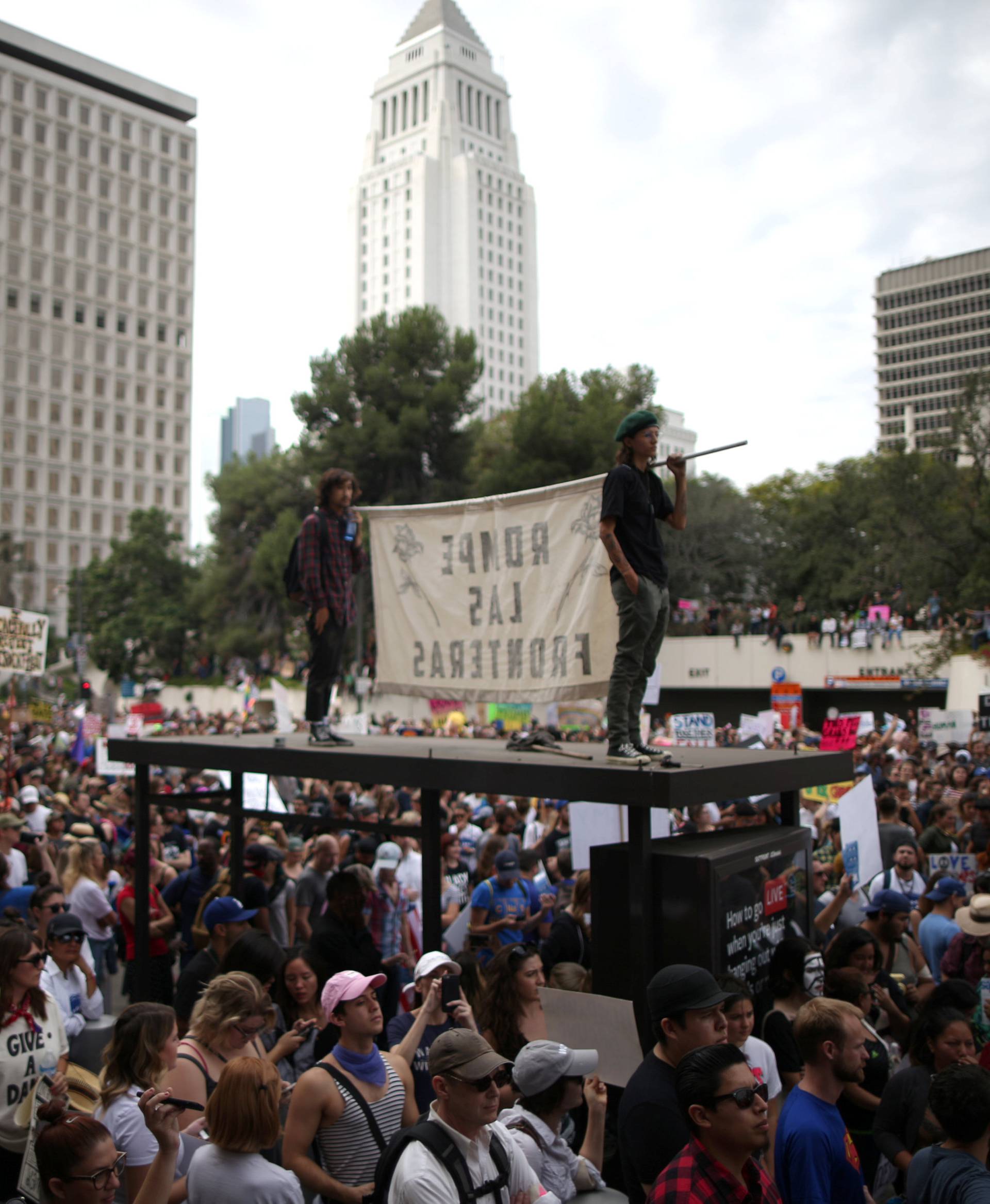 People gather outside a federal building during a march and rally against the election of Republican Donald Trump as President of the United States in Los Angeles