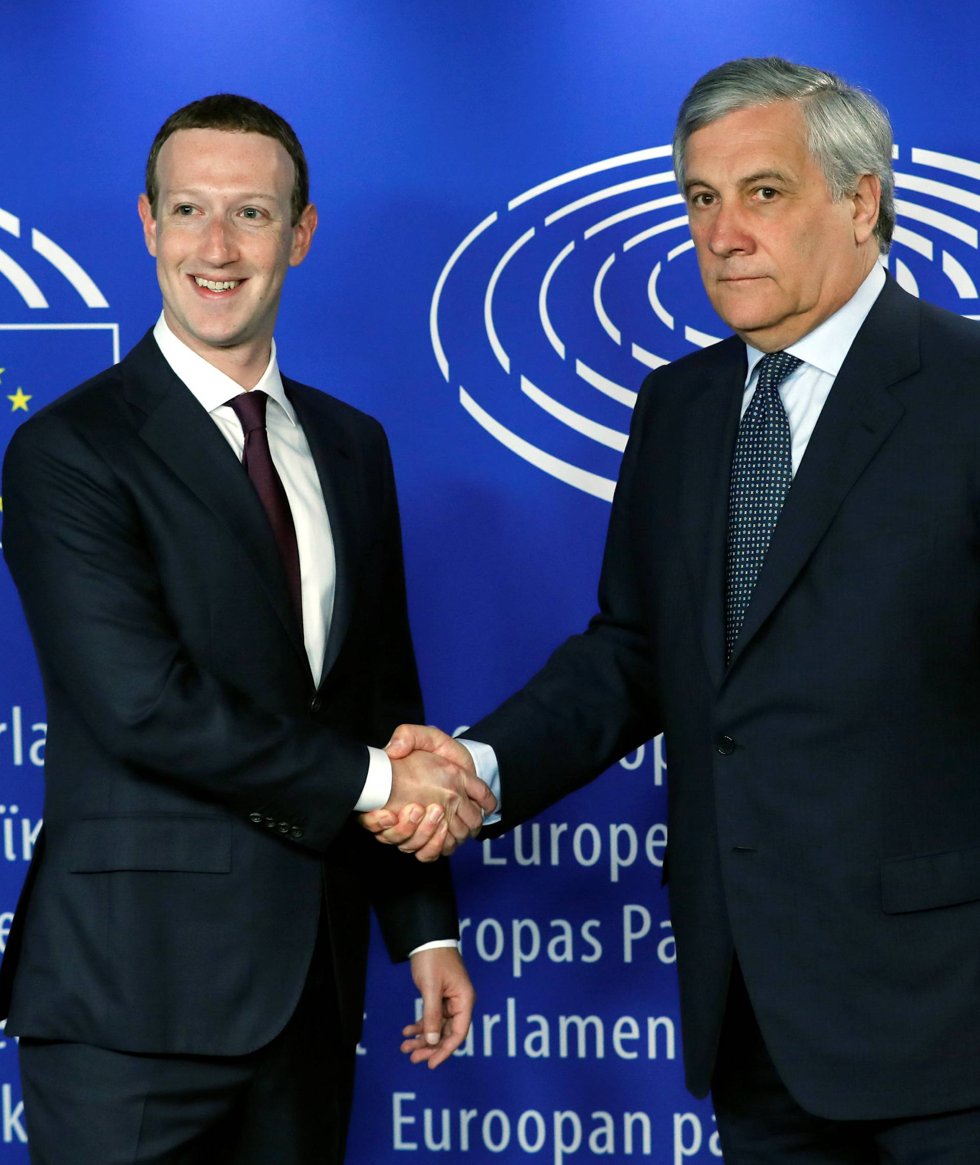 Facebook's CEO Mark Zuckerberg shakes hands with European Parliament President Antonio Tajani at the European Parliament in Brussels