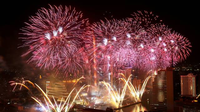 Fireworks explode over Chao Phraya River during the New Year celebrations in Bangkok