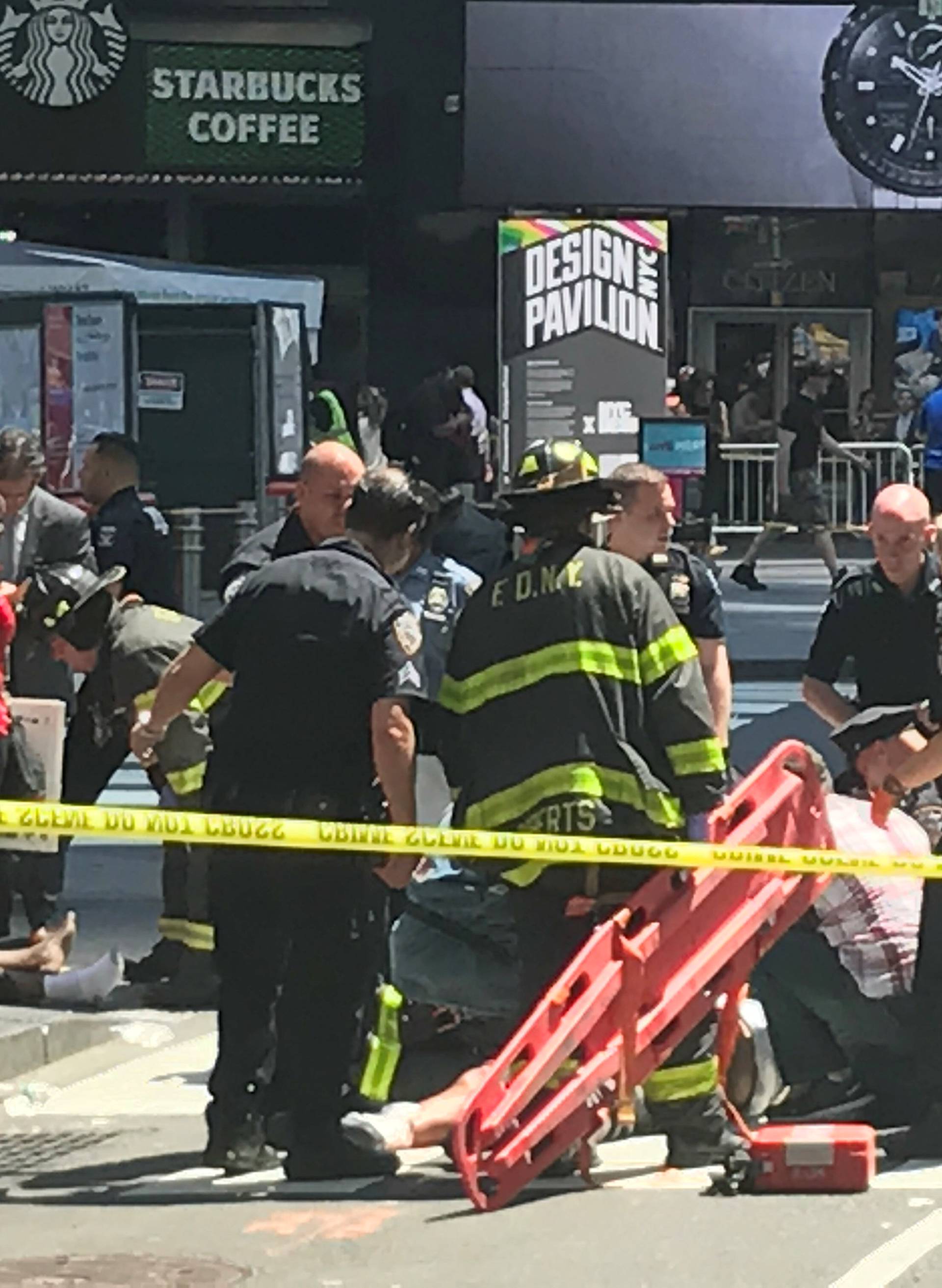 First responders are assisting injured pedestrians after a vehicle struck pedestrians on a sidewalk in Times Square in New York