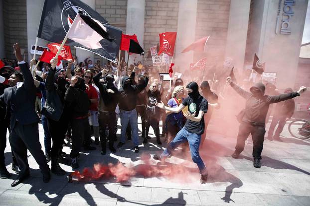 Protestors set off a flare during a demonstration at the Guildhall following Britain