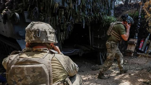 Ukrainian service members fire an M109L self-propelled howitzer towards Russian troops near a front line, in Donetsk region