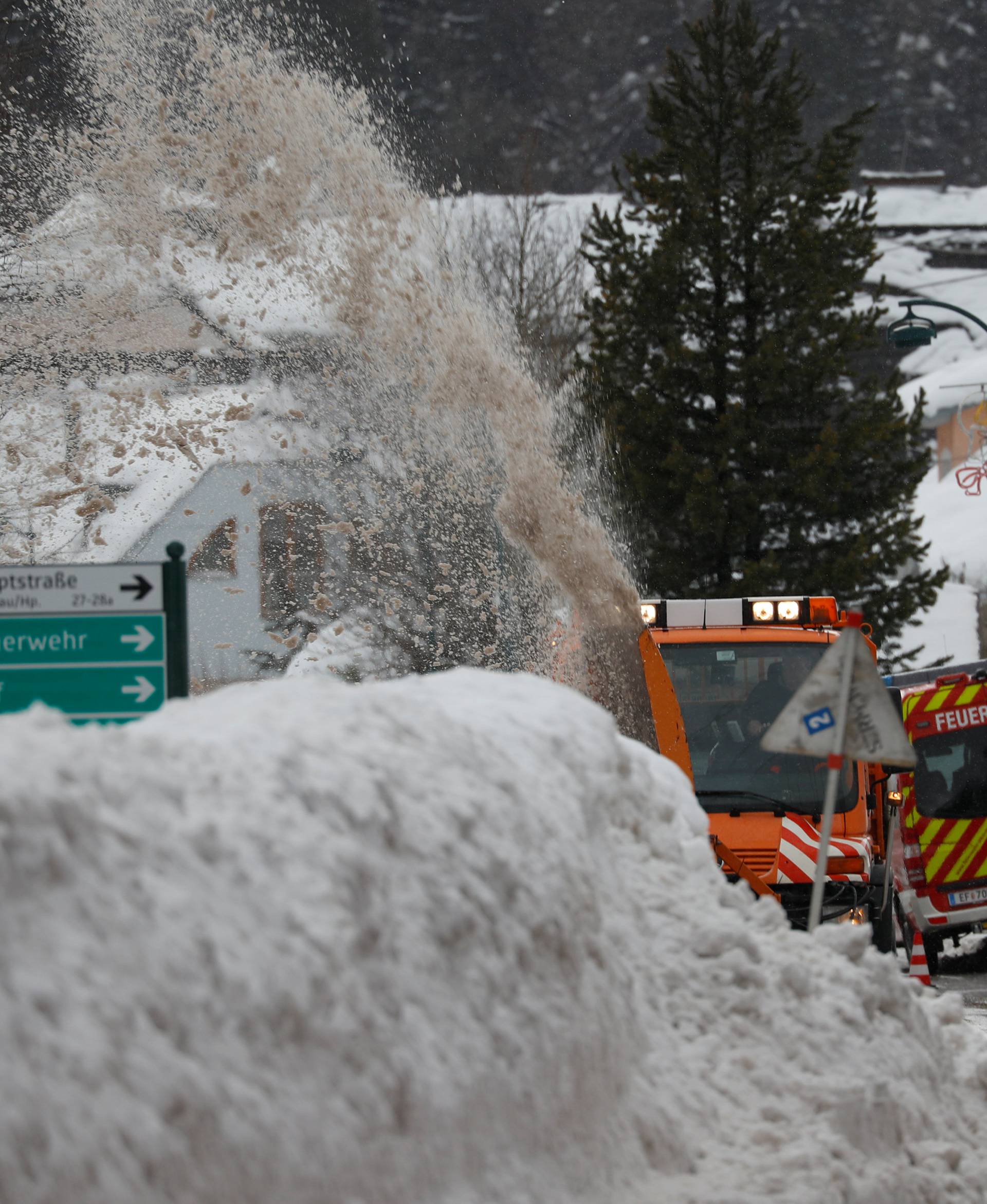 A vehicle removes snow on a road after heavy snowfall in Rosenau