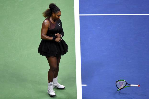 FILE PHOTO: Serena Williams of the United States smashes her racket on day thirteen of the 2018 U.S. Open tennis tournament in New York