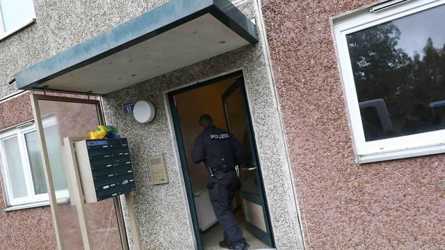 German police officer enters a building, that also serves as an accommodation facility for refugees, in Suhl