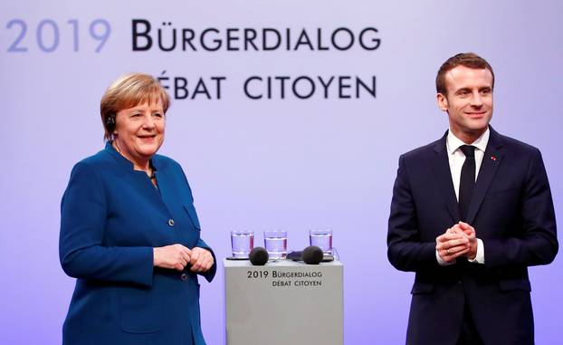 German Chancellor Angela Merkel and French President Emmanuel Macron attend a discussion with citizens, in Aachen