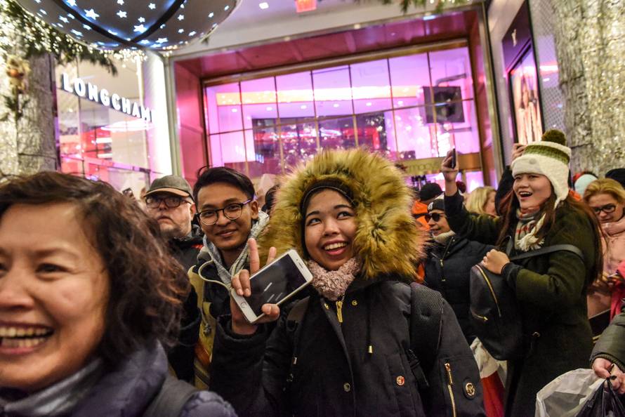 People rush in after the doors are opened during a Black Friday sales event at Macy's flagship store in New York