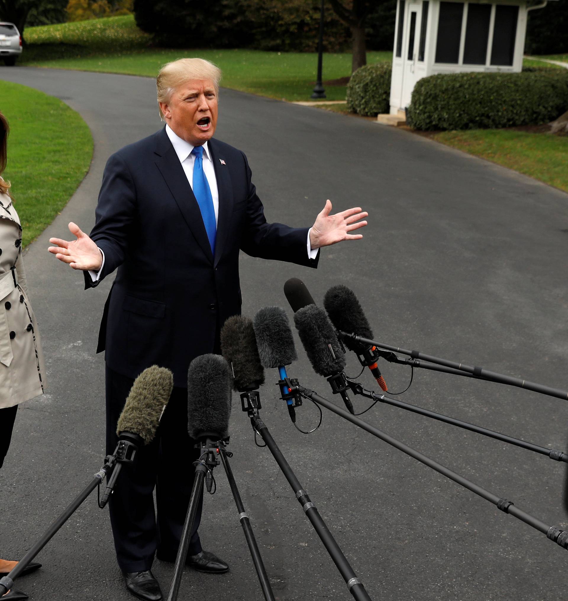 Trump speaks to reporters as he leaves the White House in Washington