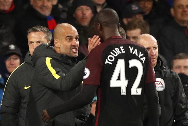 Manchester City manager Pep Guardiola speaks to Yaya Toure