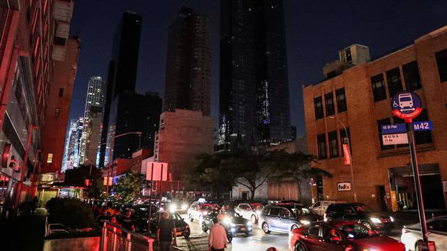 A residential building light out near Times Square area, as a blackout affects buildings and traffic during widespread power outages in the Manhattan borough of New York