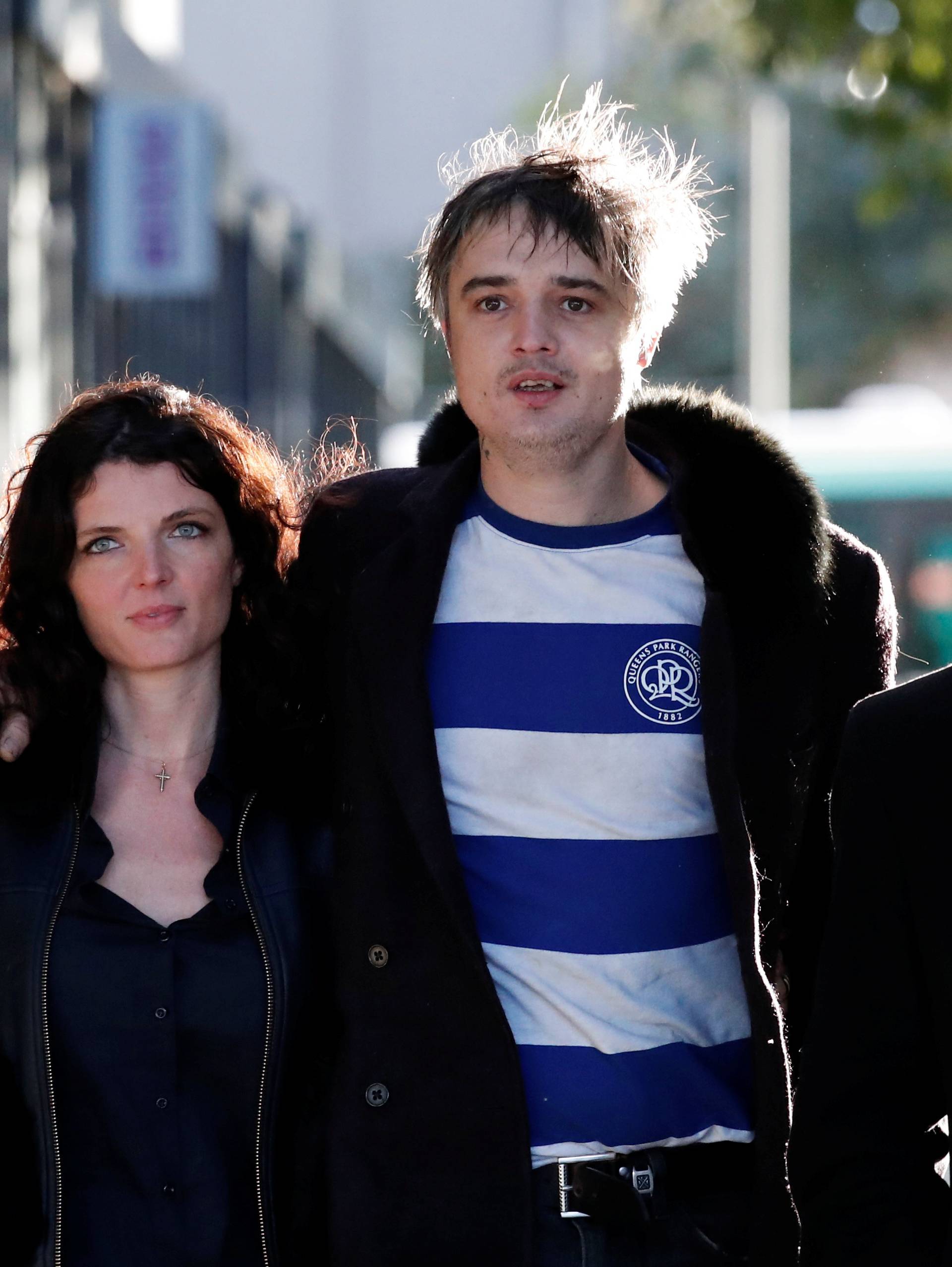 British rocker Pete Doherty leaves the Paris court with his friend Katia De Vidas and his lawyer Arash Derambarsh in Paris