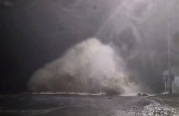 A wave crashes into land as tides rise due to Cyclone Gabrielle in Waiwera, Auckland