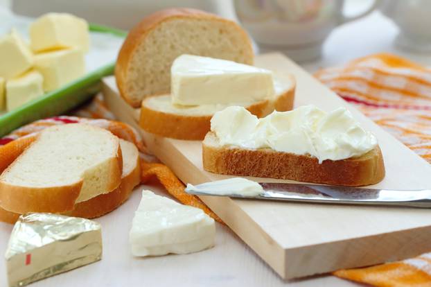 Slice of bread with cream cheese and butter for breakfast