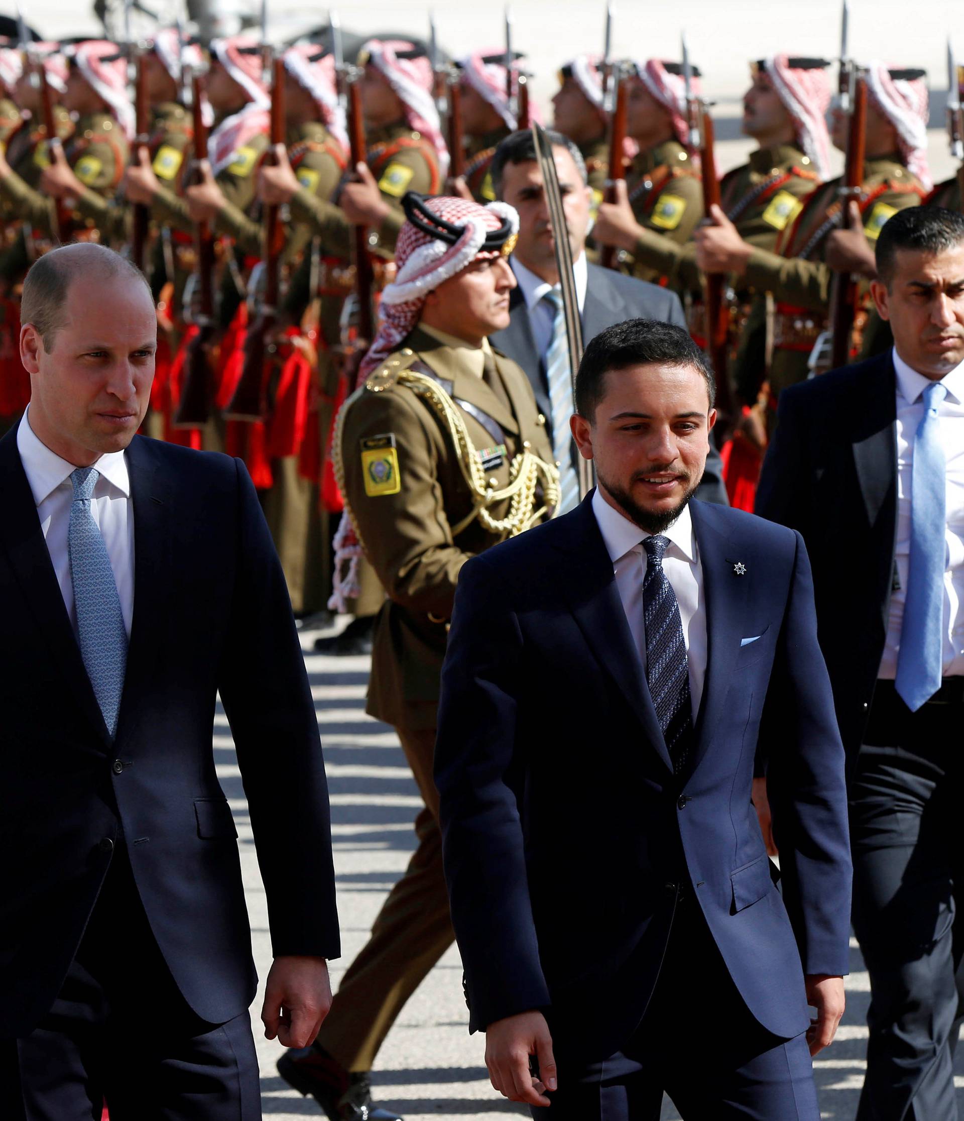 Britain's Prince William and Jordan's Crown Prince Hussein bin Abdullah II review the honour guard in Amman