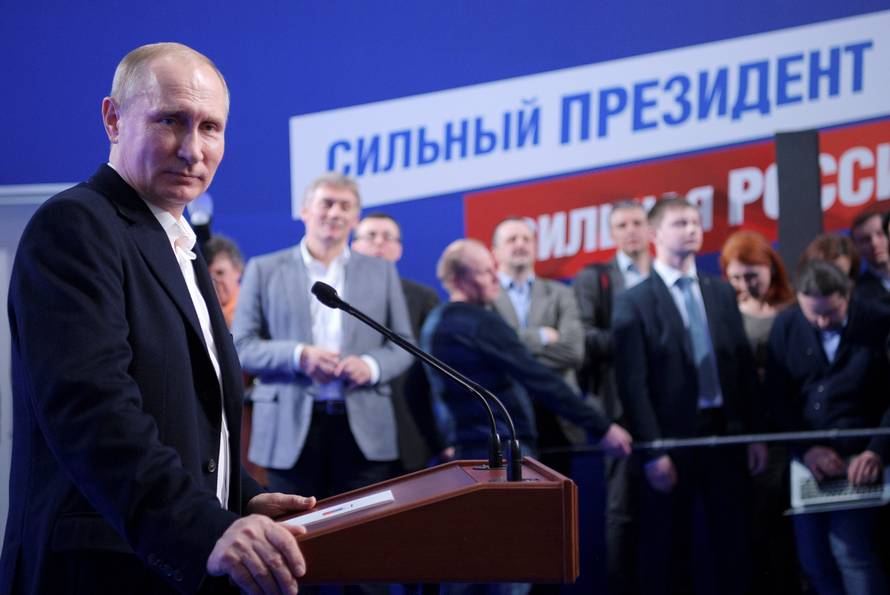 Russian President and Presidential candidate Vladimir Putin attends a news conference at his campaign headquarters in Moscow