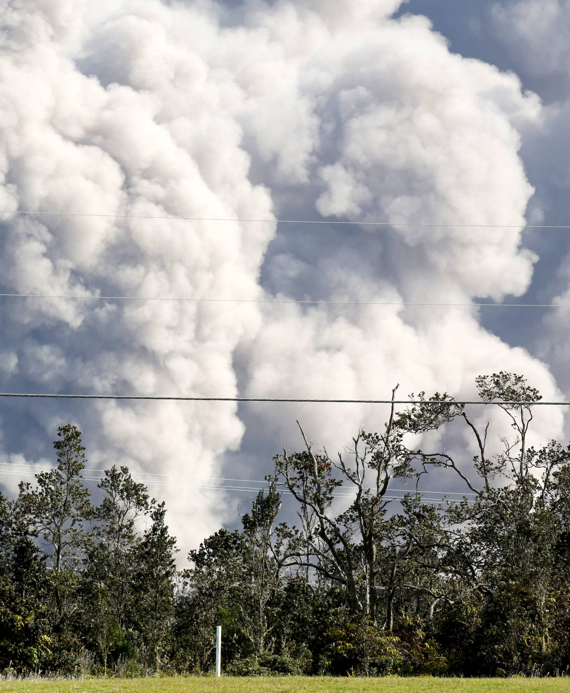 Ash erupts from Halemaumau Crater near the community of Volcano