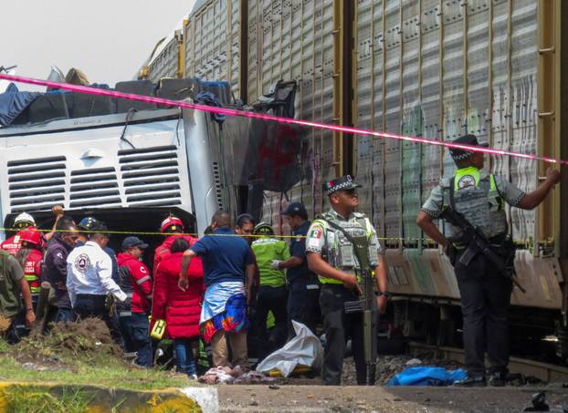 Authorities work at the scene where a passenger bus was struck by a train, in Atlacomulco