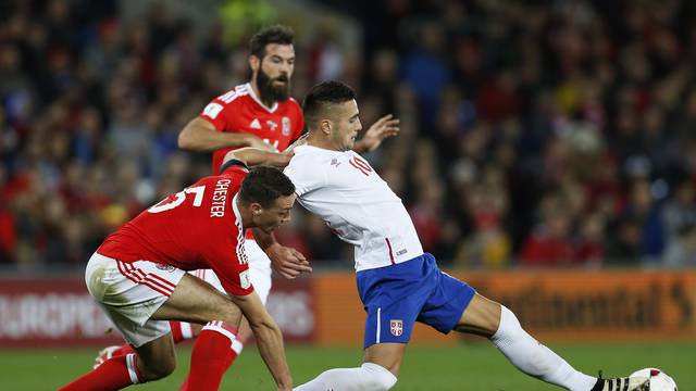 Serbia's Dusan Tadic in action with Wales' James Chester