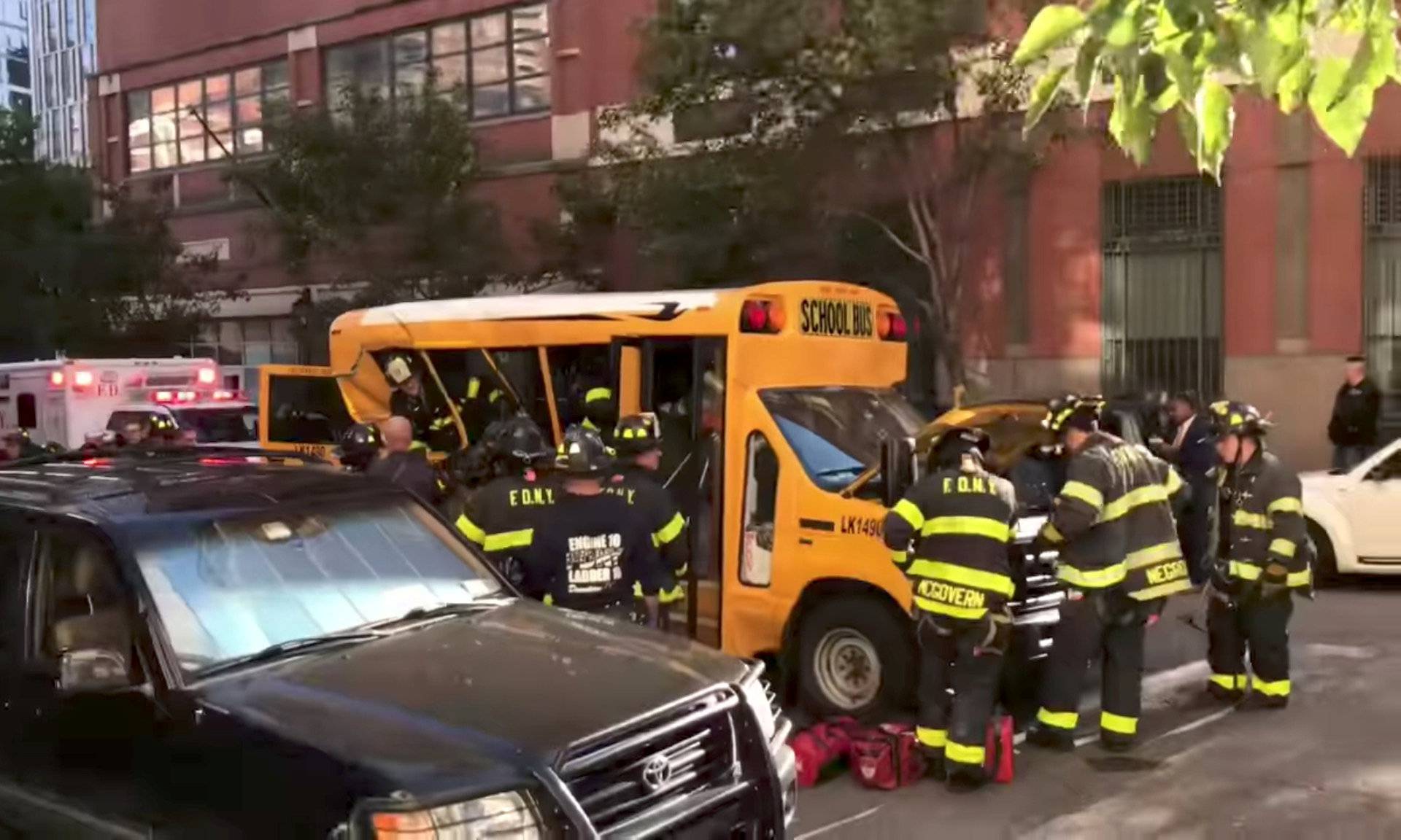 Authorities are seen at a damaged school bus near the scene of a pickup truck attack in Manhattan, New York