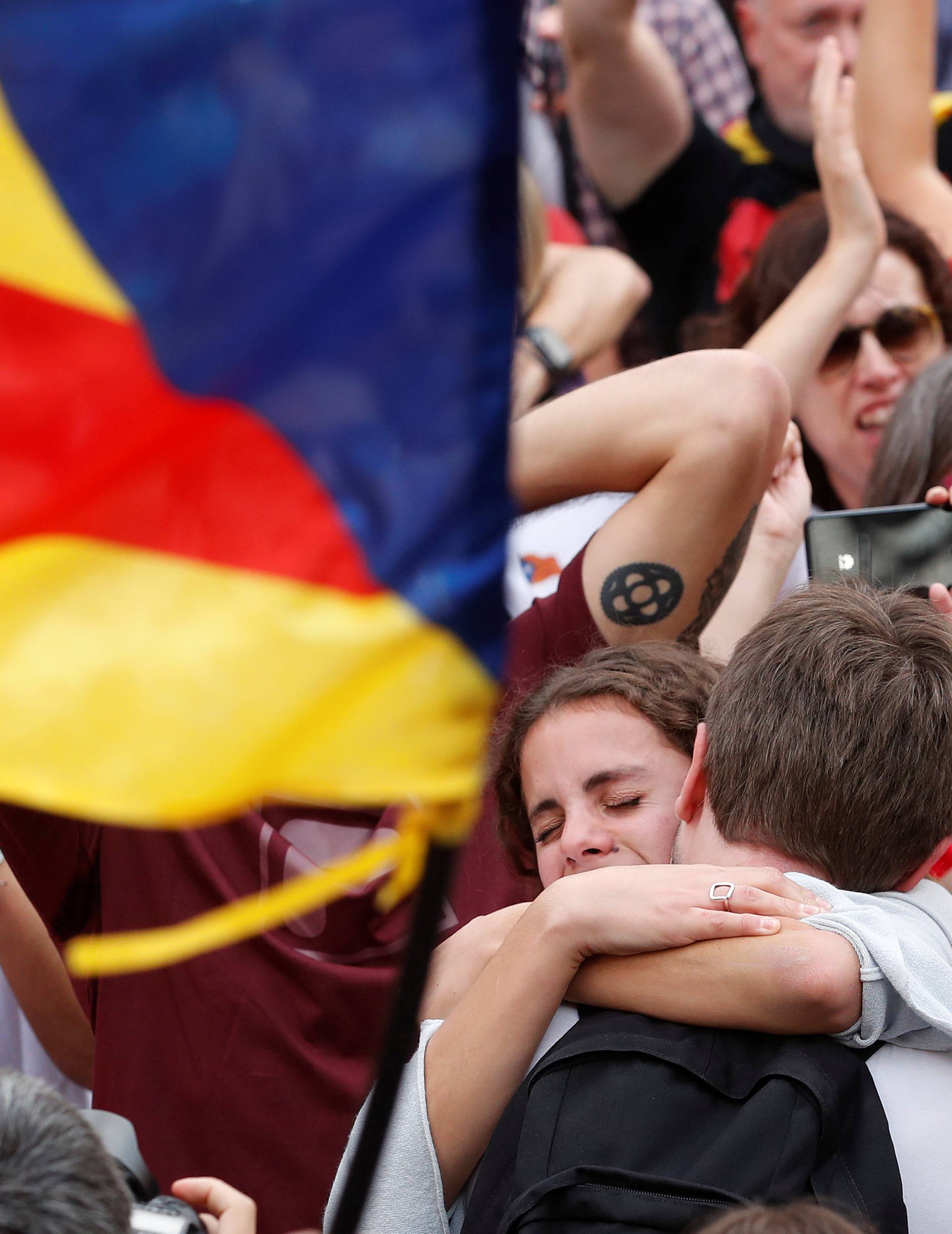 People celebrate after the Catalan regional parliament passes the vote of independence from Spain in Barcelona