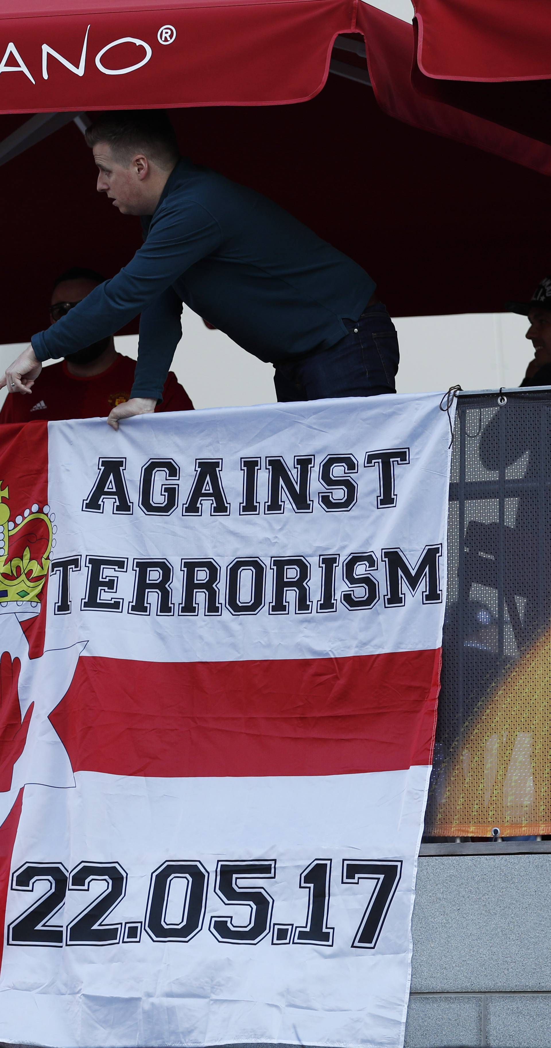 Manchester United fans display a banner in reference to the terror attack in Manchester before the match