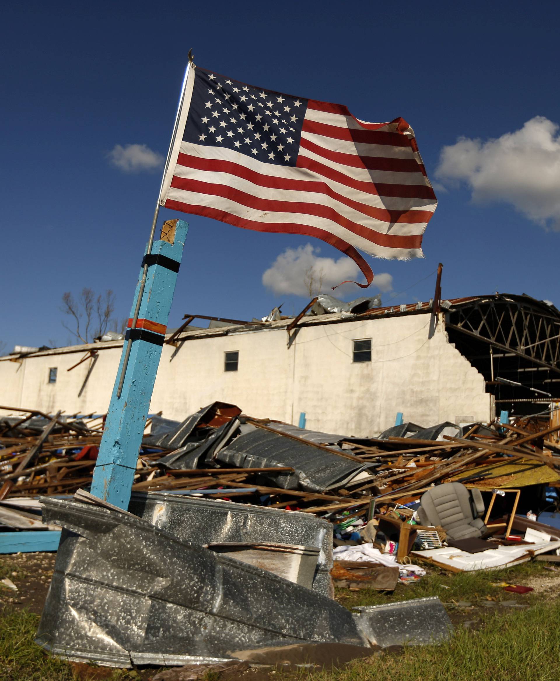 A U.S. flag flies in front of a building damaged by Hurricane Michael in Panama City