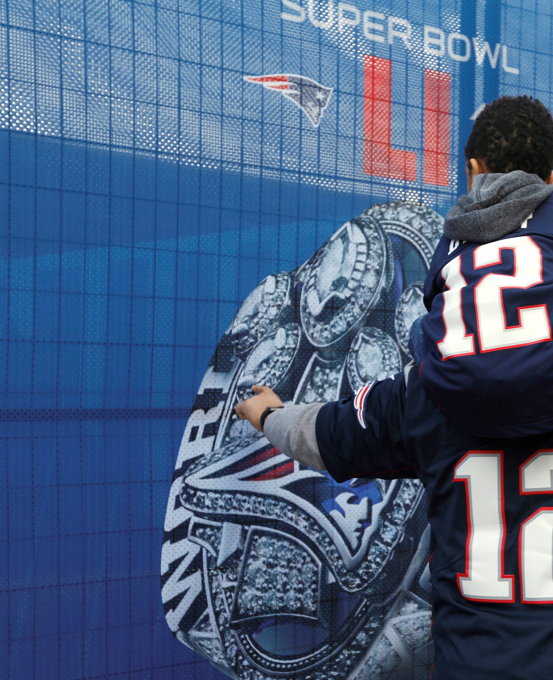 FILE PHOTO: Father and son in Patriots jerseys at the Super Bowl in Atlanta