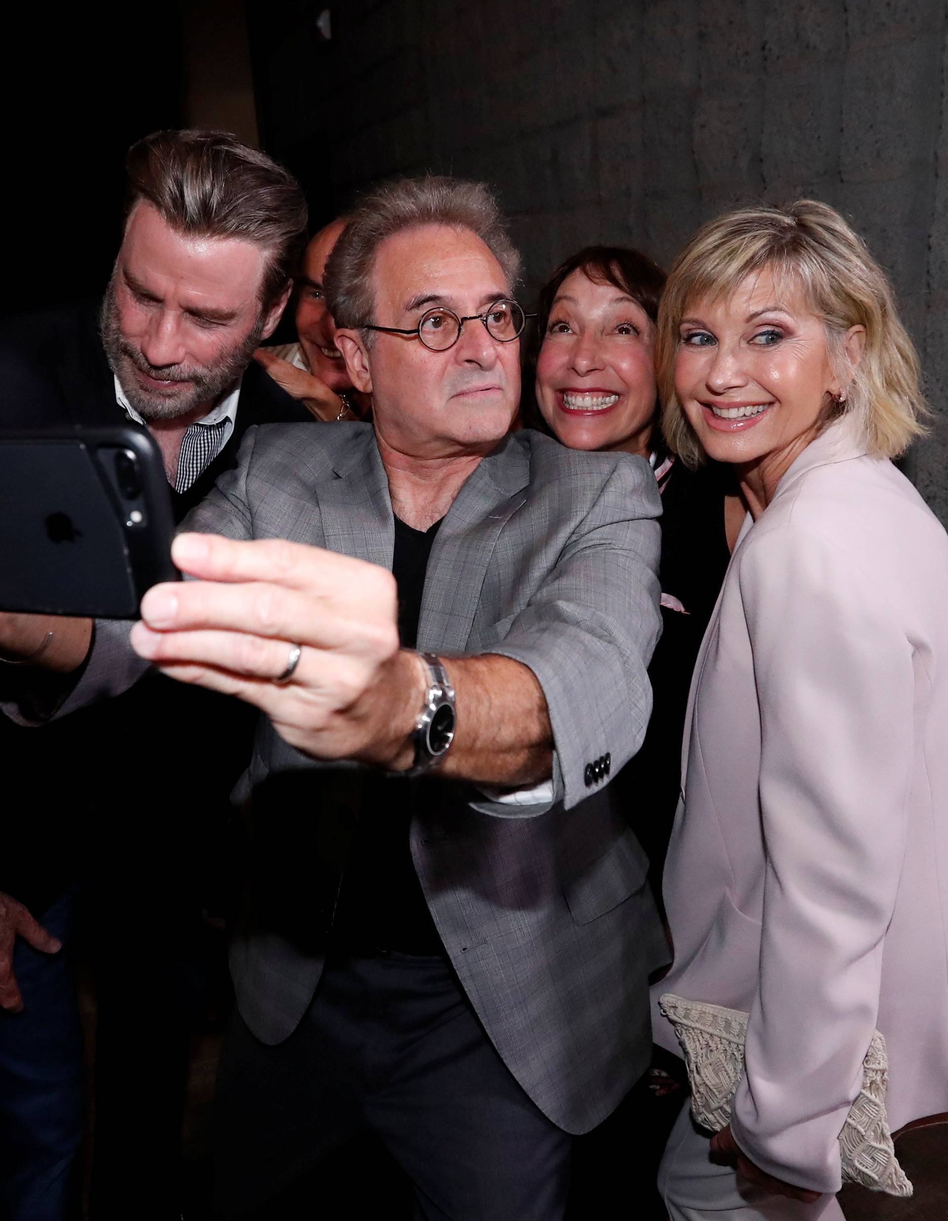 Cast members Travolta, Pearl, Conn and Newton-John pretend to look away as they pose for a selfie at a 40th anniversary screening of "Grease" at the Academy of Motion Picture Arts and Sciences in Beverly Hills