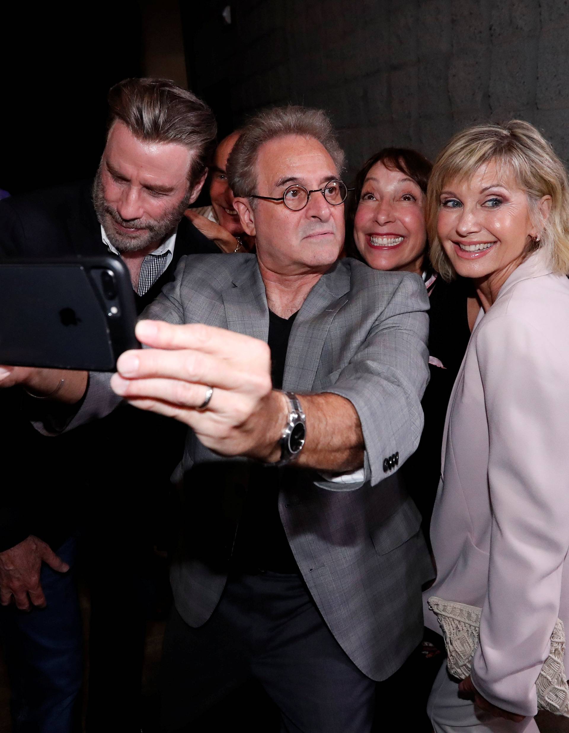 Cast members Travolta, Pearl, Conn and Newton-John pretend to look away as they pose for a selfie at a 40th anniversary screening of "Grease" at the Academy of Motion Picture Arts and Sciences in Beverly Hills