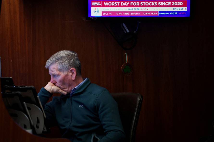 Traders work on the floor of the NYSE in New York