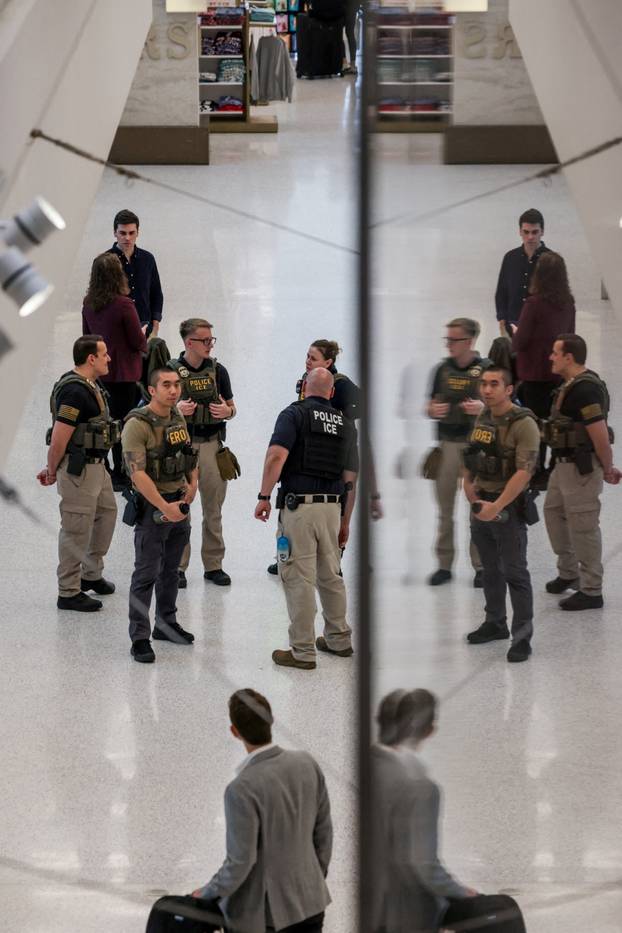 Immigration and Customs Enforcement agents walk at Newark Liberty International Airport