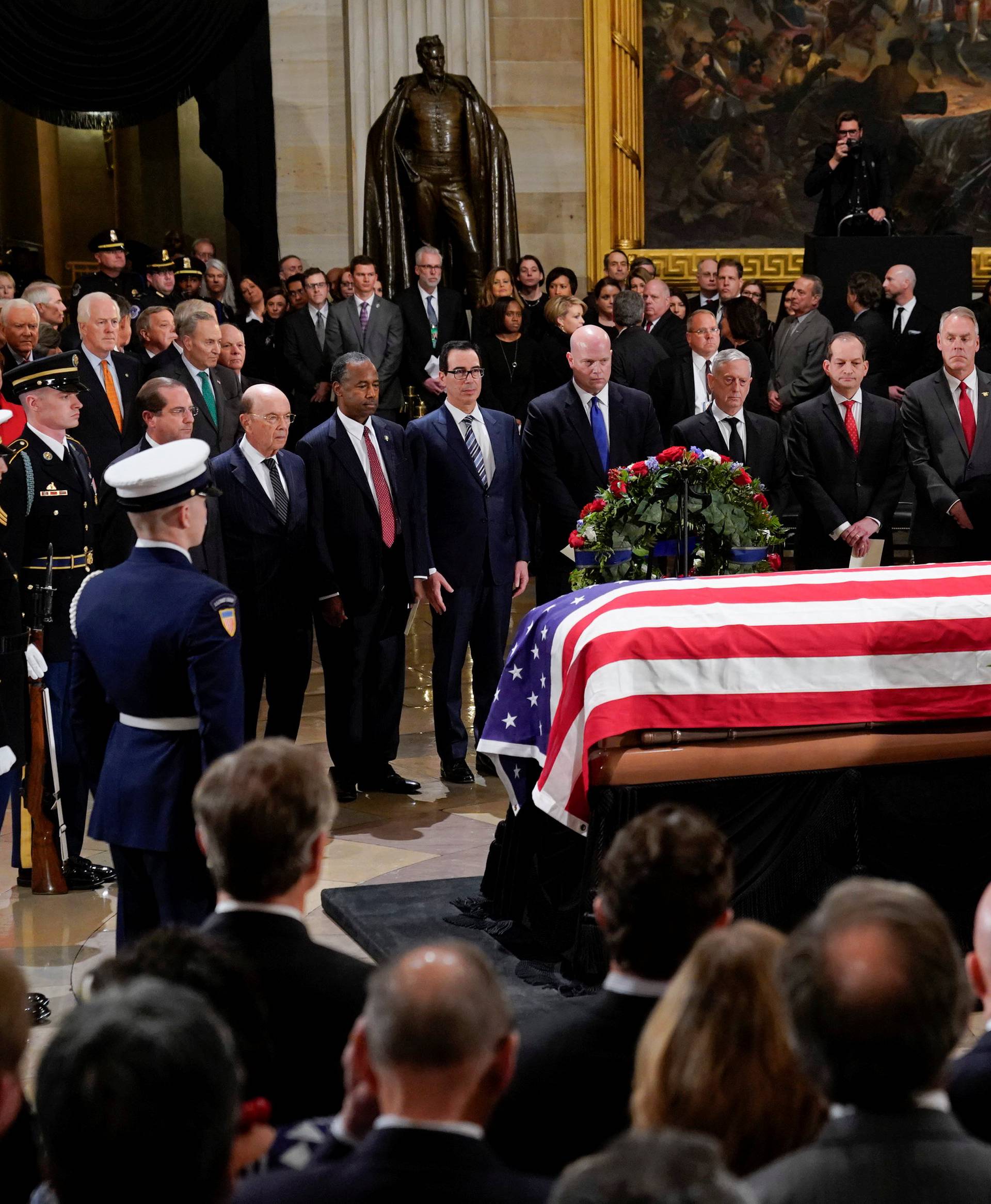 Members of President Donald Trump's cabinet stop to pay their respect in front of the flag-draped casket of former President George H.W. Bush at the Capitol in Washington