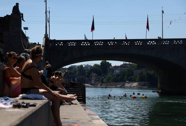 People swim in the Rhine river during a heatwave in Basel