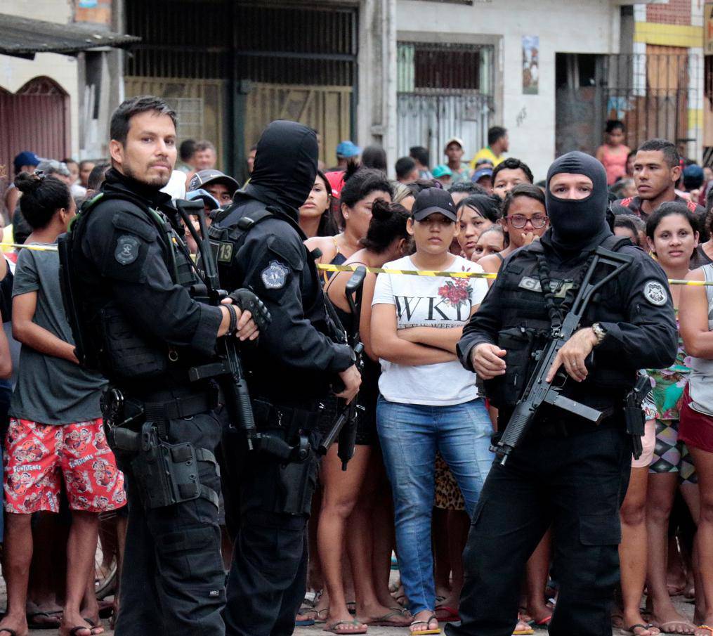 Policemen are seen at a site where, according to local media, an armed group entered and opened fire at a bar, killing and wounding its patrons, in Belem