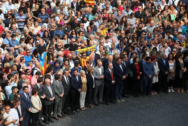 Catalan regional government members and local politicians stand in Plaza Sant Jaume as they join a protest called by pro-independence groups for citizens to gather at noon in front of city halls throughout Catalonia, in Barcelona