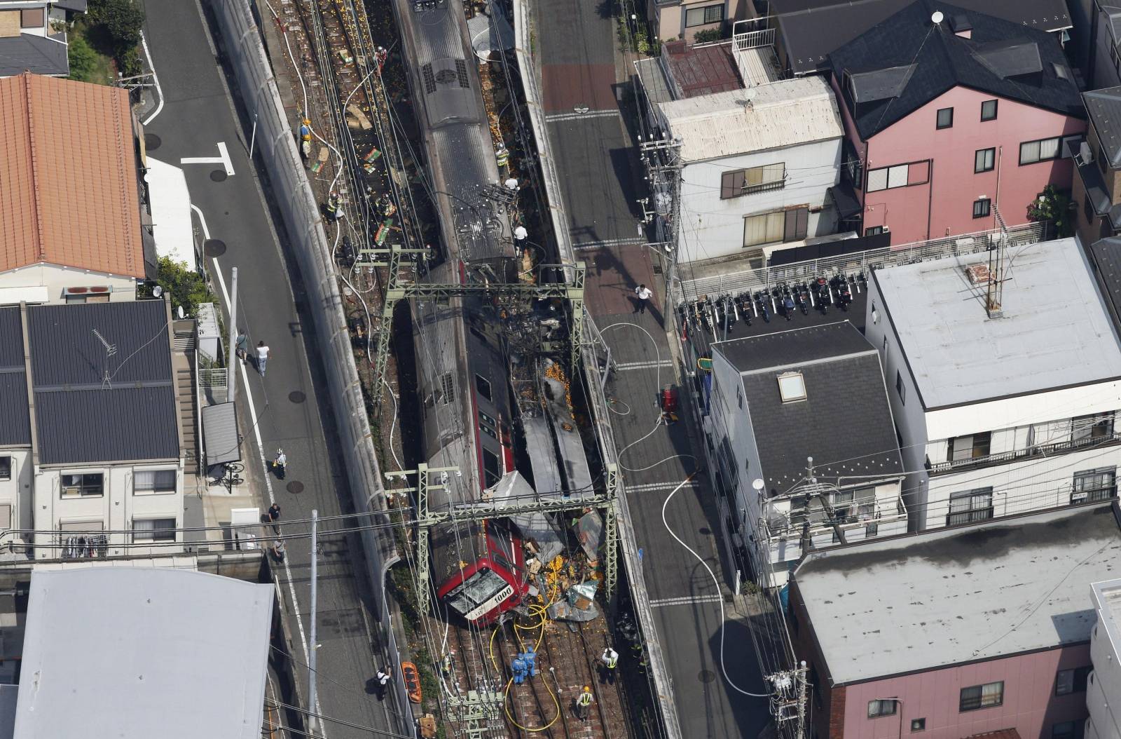 A train is seen as it is derailed after a collision with a truck in Yokohama