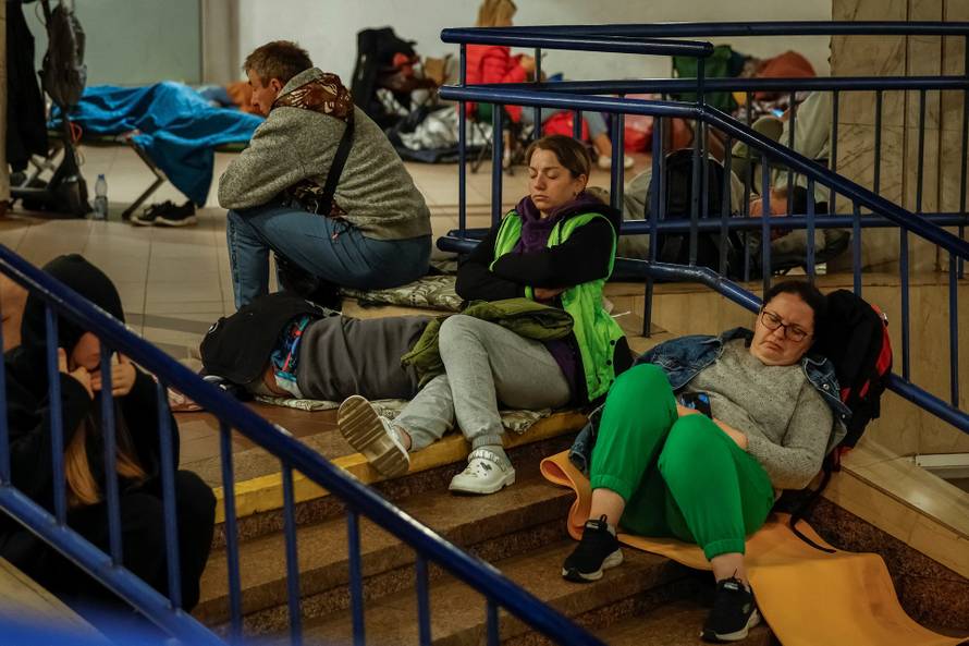 People take shelter inside a metro station during a Russian missile and drone attack in Kyiv
