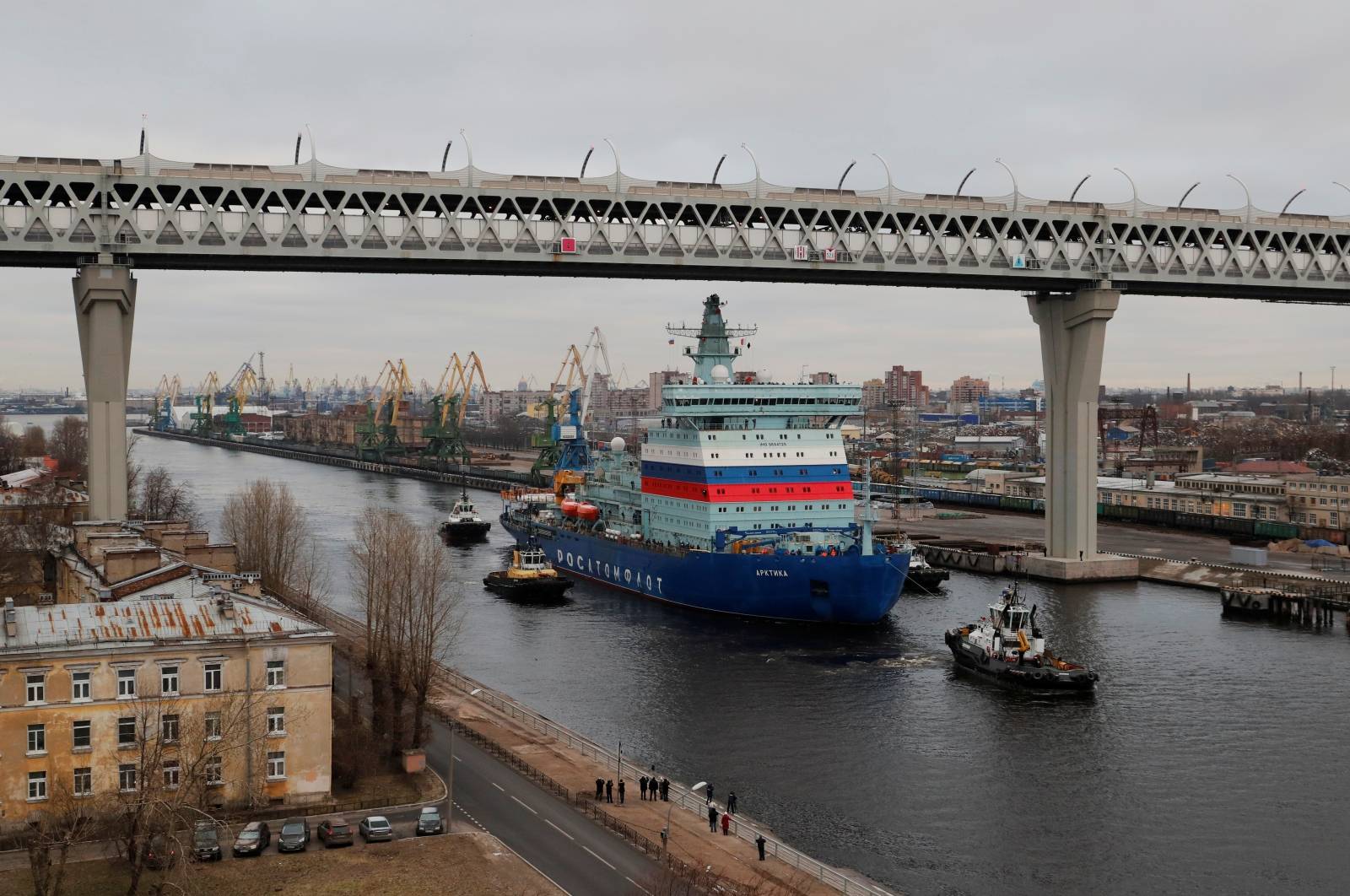 The nuclear-powered icebreaker Arktika is seen drawn by tug boats as it starts the sea trials, in Saint Petersburg