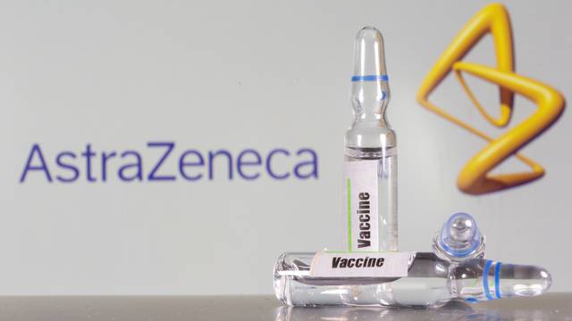 FILE PHOTO: A test tube labelled with the vaccine is seen in front of AstraZeneca logo in this illustration taken