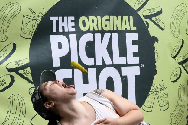 Visitors to Picklesburgh Try Catching Pickles in their Mouth